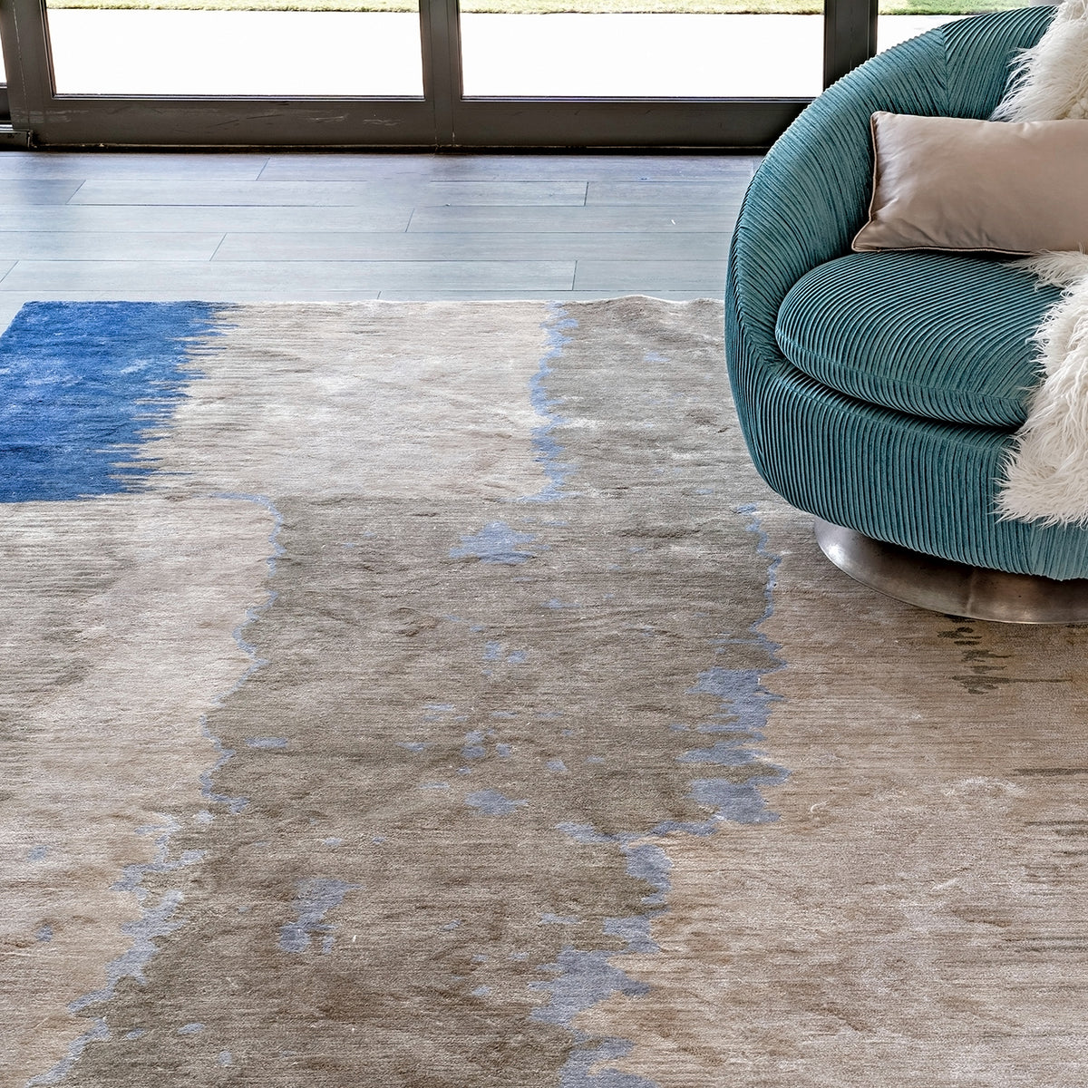 Handmade bamboo silk rug with layered blue tones inspired by the Greek island of Santorini and Mediterranean coastal landscapes.