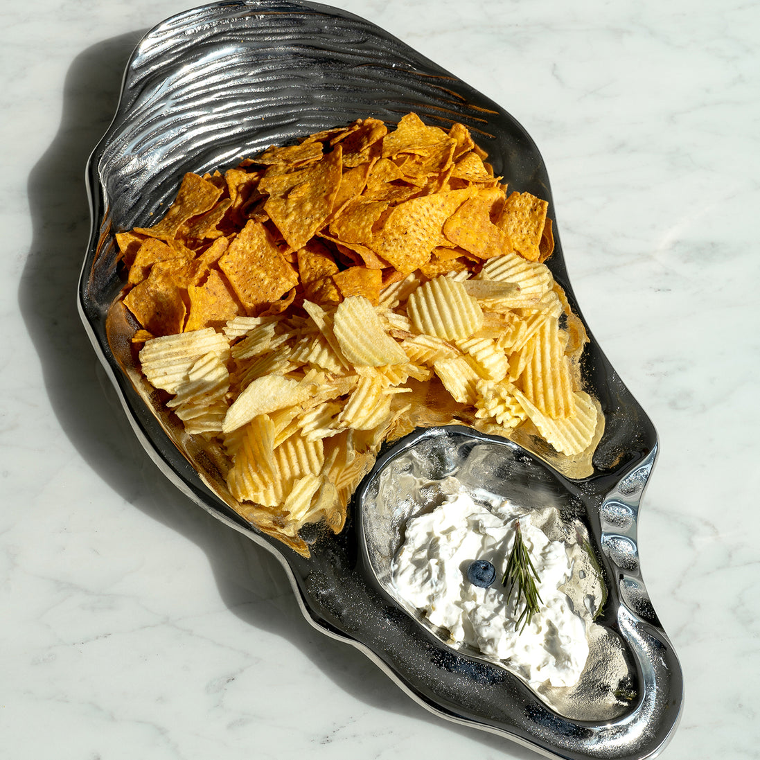 Seashell silver decorative platter with intricate shell design, coastal-inspired luxury home décor accent.