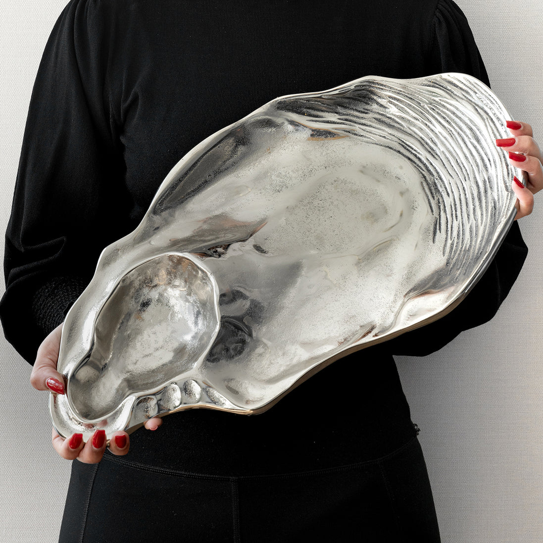 Seashell silver decorative platter with intricate shell design, coastal-inspired luxury home décor accent.