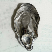 Seashell silver decorative platter with intricate shell design, coastal-inspired luxury home décor accent.