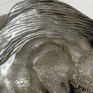 Seashell silver decorative platter with intricate shell design, coastal-inspired luxury home décor accent.