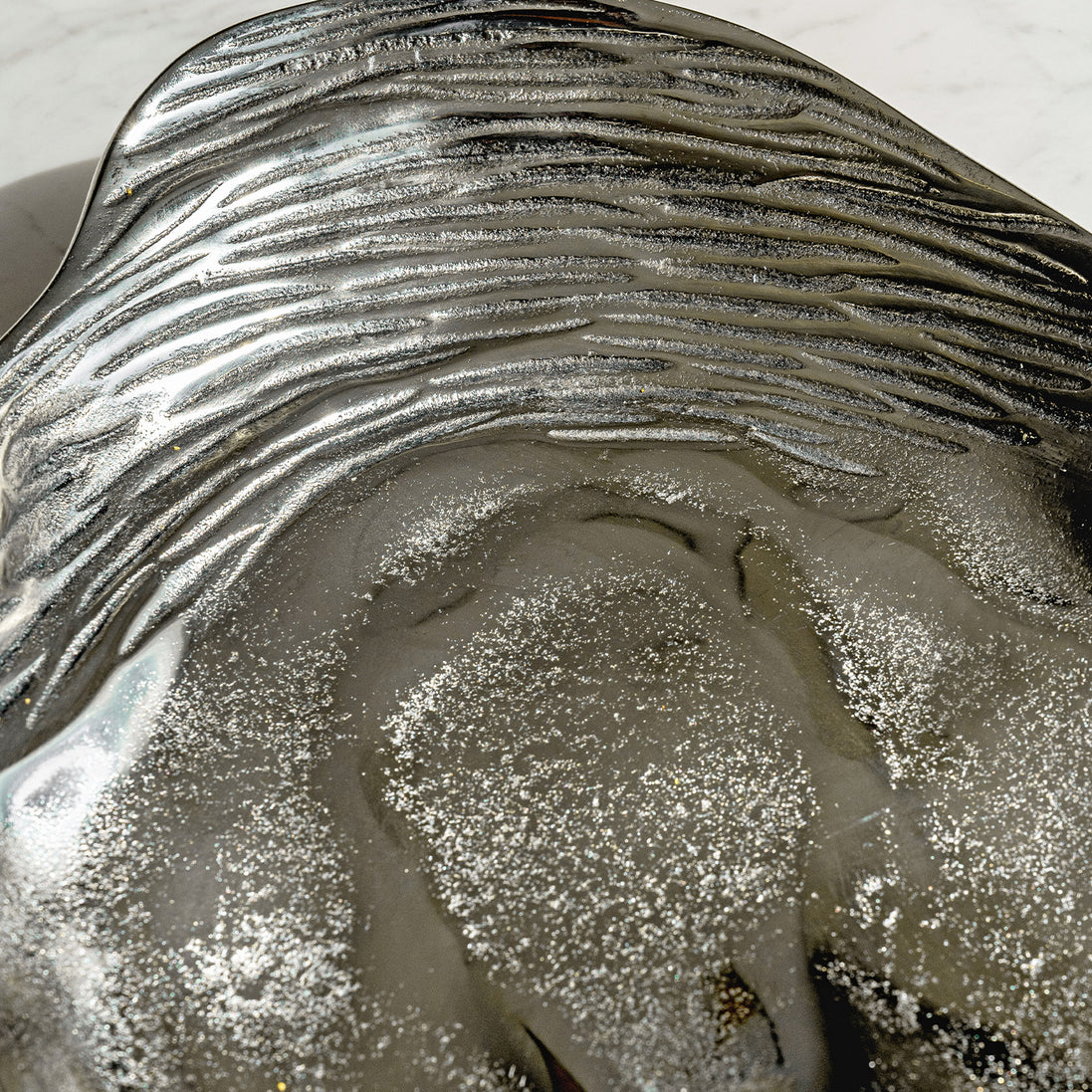 Seashell silver decorative platter with intricate shell design, coastal-inspired luxury home décor accent.