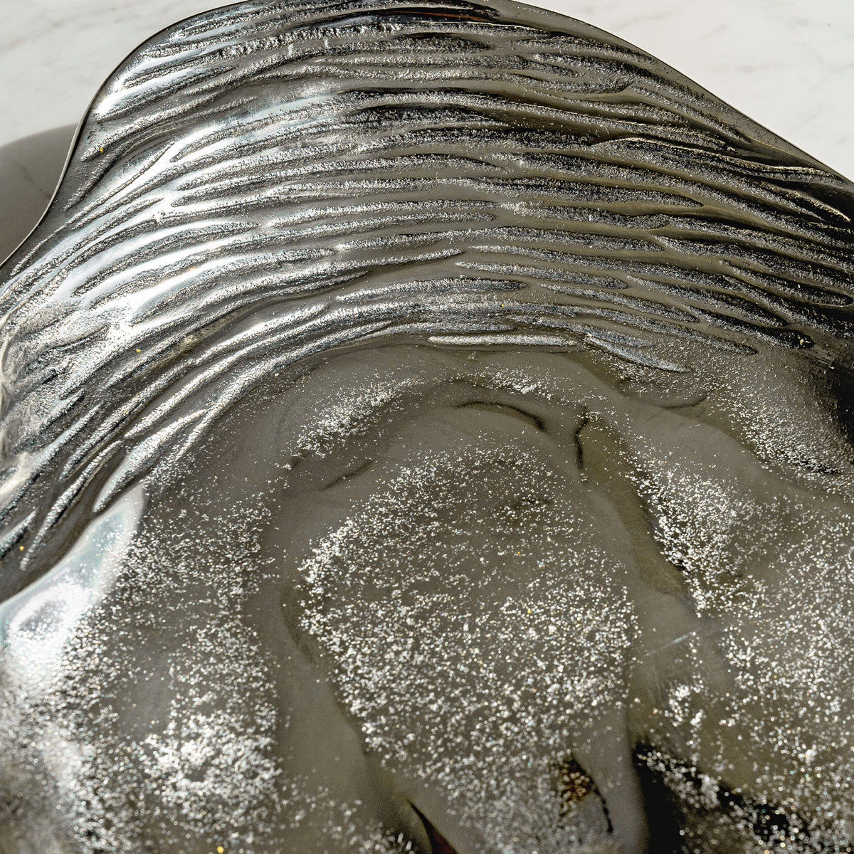 Seashell silver decorative platter with intricate shell design, coastal-inspired luxury home décor accent.