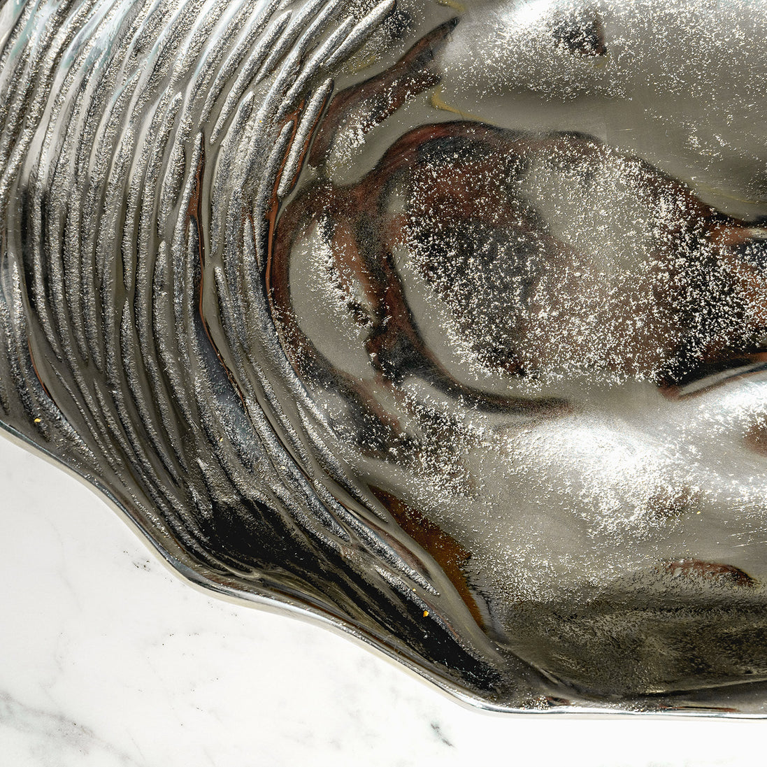 Seashell silver decorative platter with intricate shell design, coastal-inspired luxury home décor accent.
