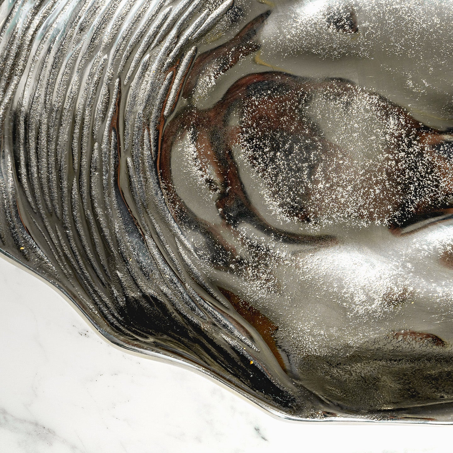 Seashell silver decorative platter with intricate shell design, coastal-inspired luxury home décor accent.