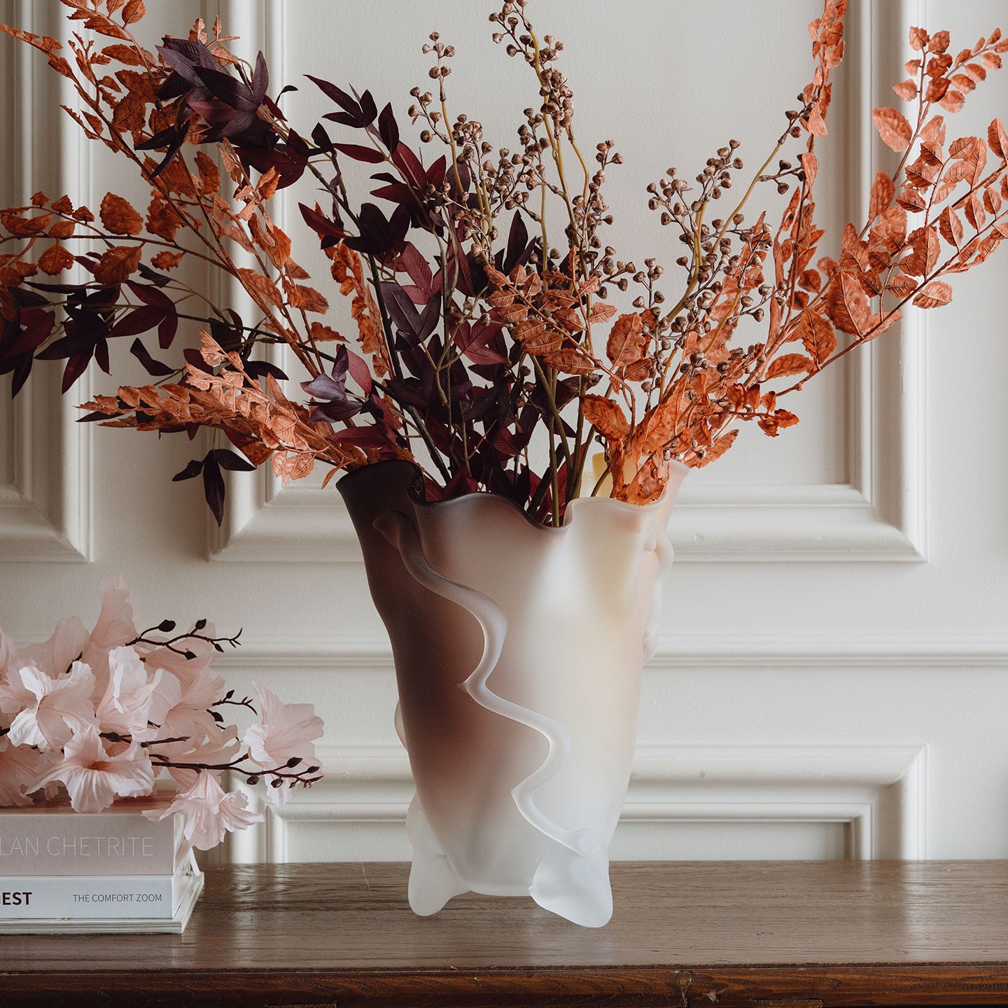 Frosted decorative glass vase with a red-to-yellow ombre finish and a sculptural floral-inspired silhouette for modern luxury interiors.
