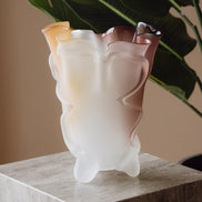 Frosted decorative glass vase with a red-to-yellow ombre finish and a sculptural floral-inspired silhouette for modern luxury interiors.