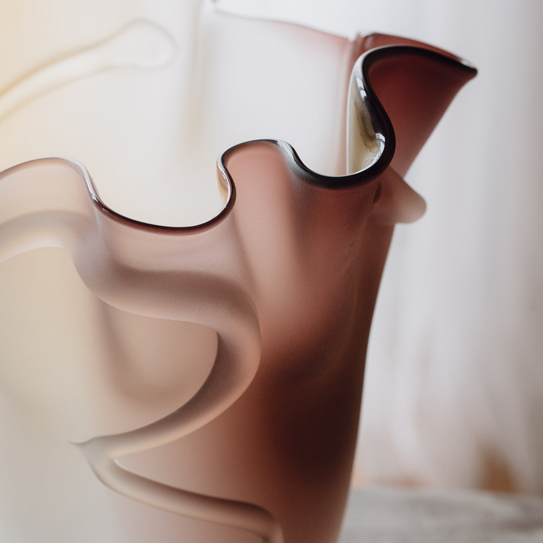 Frosted decorative glass vase with a red-to-yellow ombre finish and a sculptural floral-inspired silhouette for modern luxury interiors.