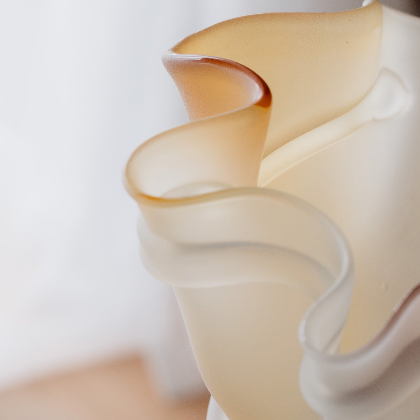 Frosted decorative glass vase with a red-to-yellow ombre finish and a sculptural floral-inspired silhouette for modern luxury interiors.