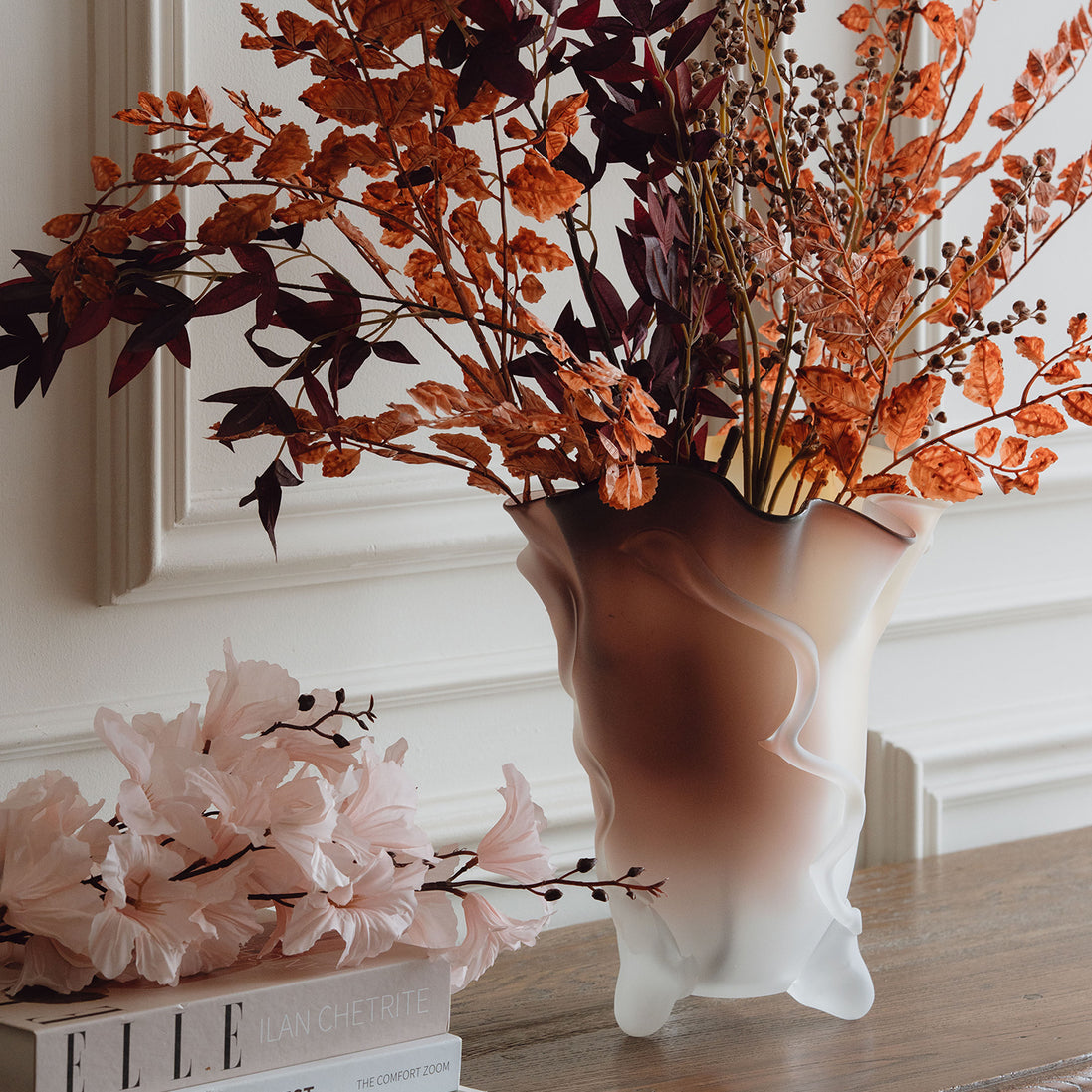 Frosted decorative glass vase with a red-to-yellow ombre finish and a sculptural floral-inspired silhouette for modern luxury interiors.