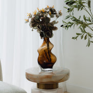 Hand-blown amber glass vase with an organic sculptural silhouette, perfect for modern and luxury interiors.
