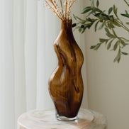 Hand-blown amber glass vase with an organic sculptural silhouette, perfect for modern and luxury interiors.