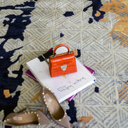 Handmade abstract rug with bold layered colours and geometric patterns for contemporary and luxury interiors.