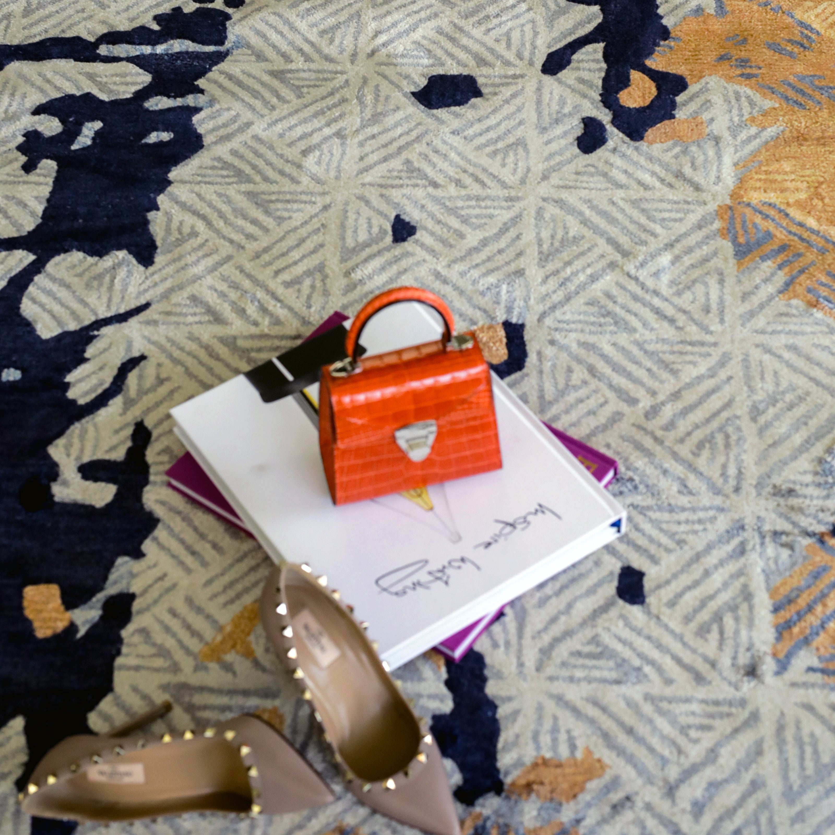 Handmade abstract rug with bold layered colours and geometric patterns for contemporary and luxury interiors.