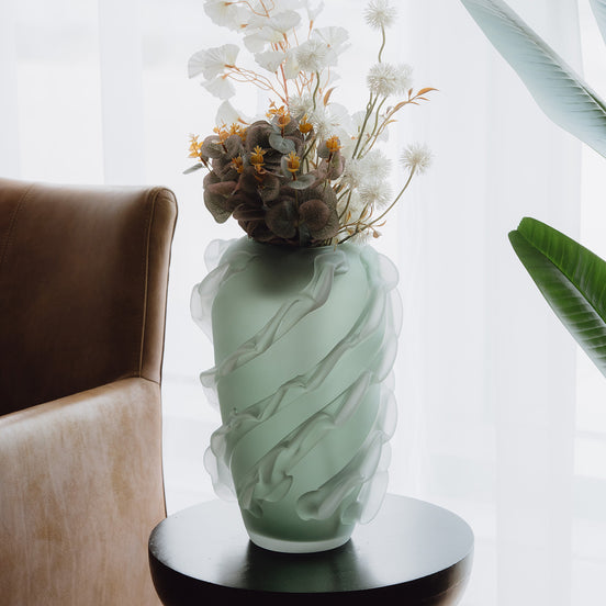 Verde is a frosted green glass vase with a sculptural wave texture, perfect for contemporary, minimalist, and luxury interiors.