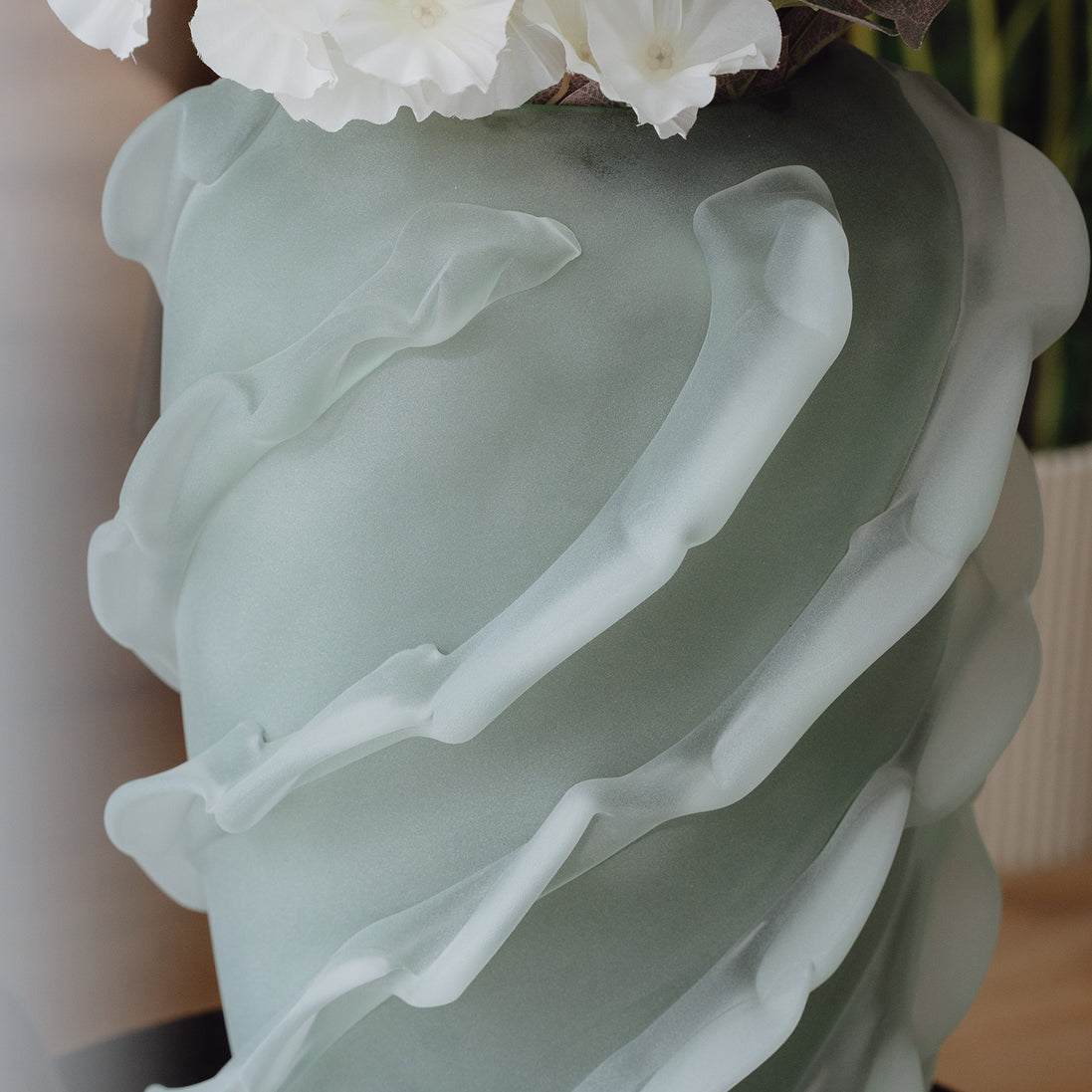 Verde is a frosted green glass vase with a sculptural wave texture, perfect for contemporary, minimalist, and luxury interiors.