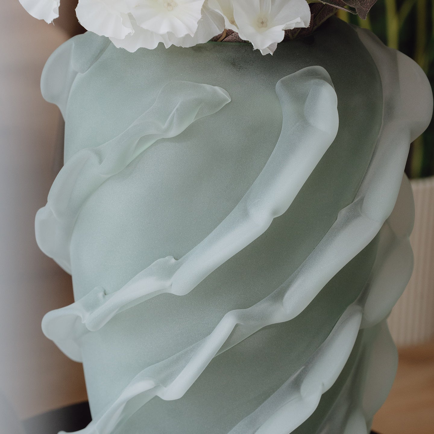 Verde is a frosted green glass vase with a sculptural wave texture, perfect for contemporary, minimalist, and luxury interiors.