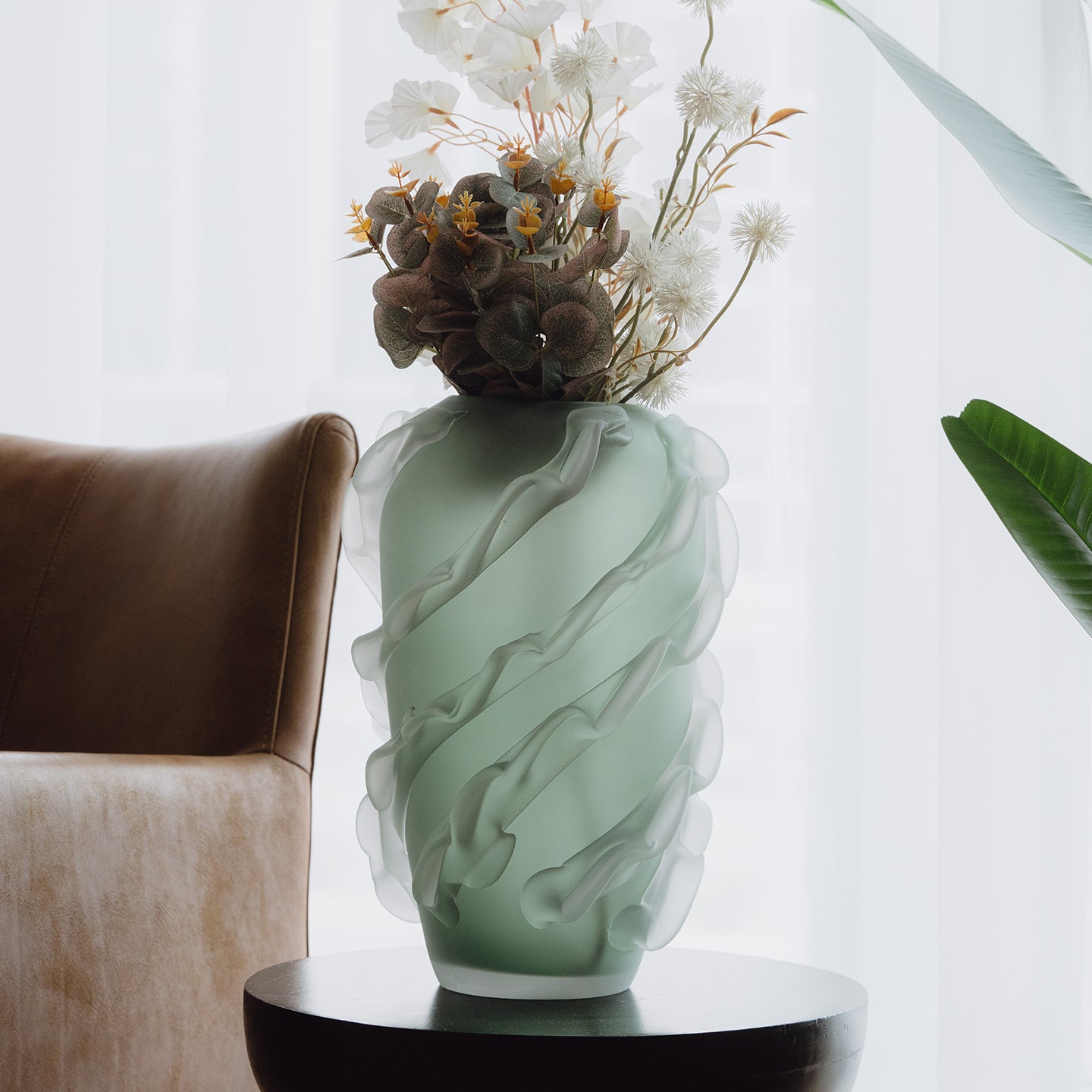 Verde is a frosted green glass vase with a sculptural wave texture, perfect for contemporary, minimalist, and luxury interiors.