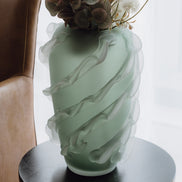 Verde is a frosted green glass vase with a sculptural wave texture, perfect for contemporary, minimalist, and luxury interiors.