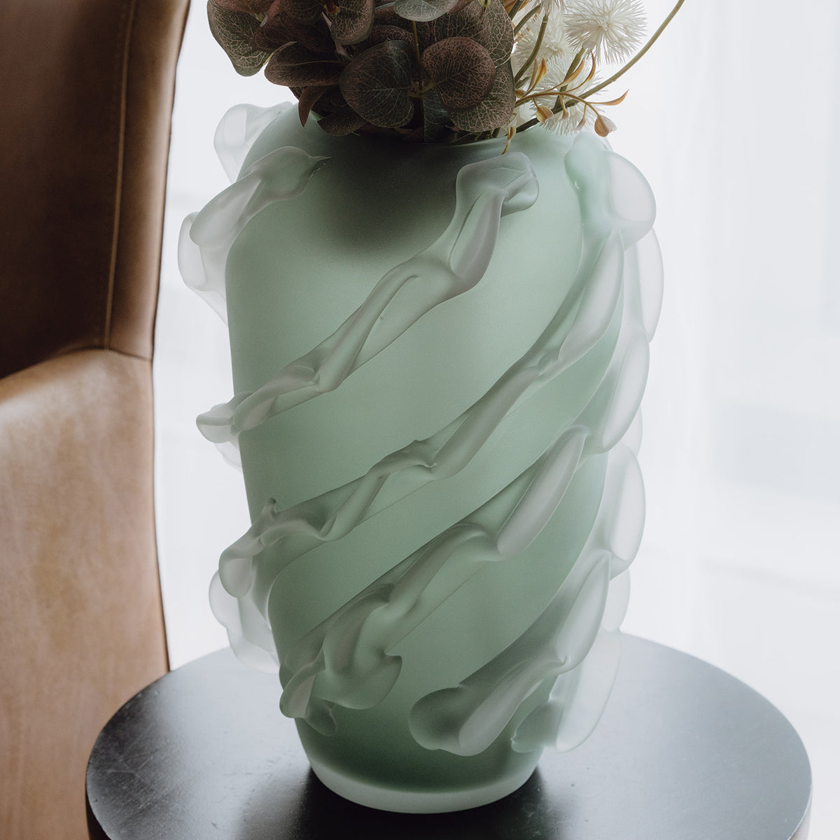 Verde is a frosted green glass vase with a sculptural wave texture, perfect for contemporary, minimalist, and luxury interiors.