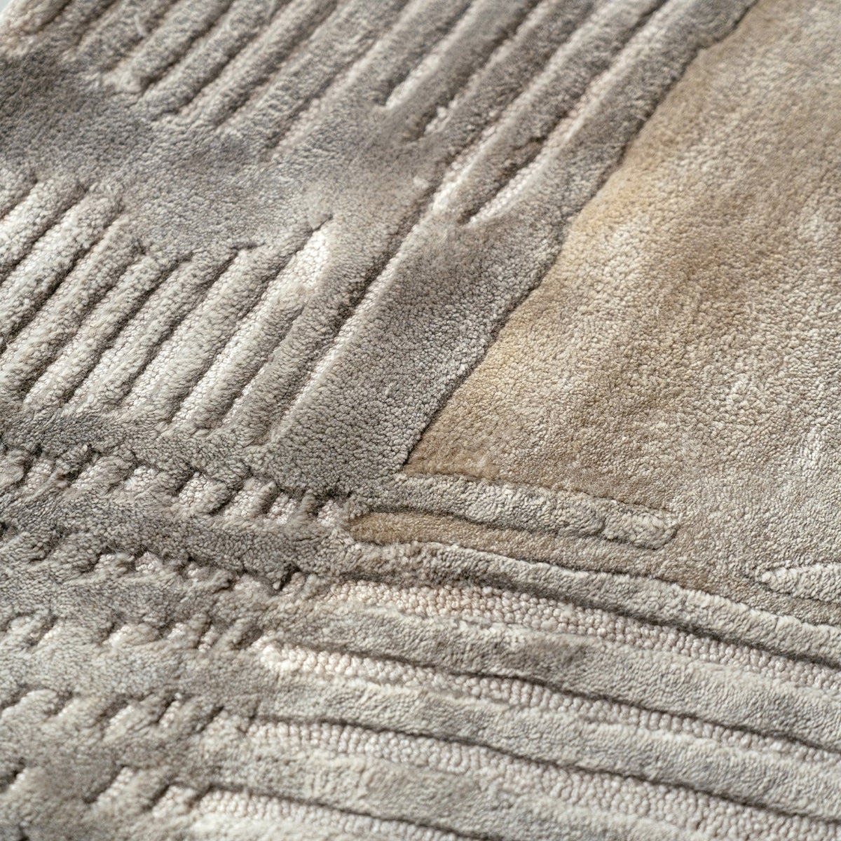Handmade bamboo silk rug with a subtle organic border inspired by the Japanese Wabi-Sabi aesthetic in soft neutral tones.