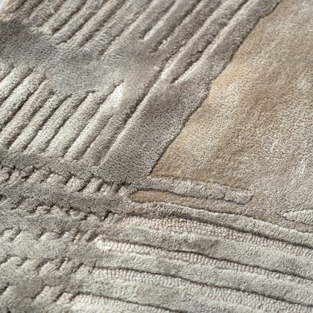 Handmade bamboo silk rug with a subtle organic border inspired by the Japanese Wabi-Sabi aesthetic in soft neutral tones.
