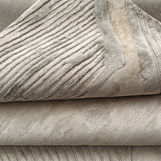 Handmade bamboo silk rug with a subtle organic border inspired by the Japanese Wabi-Sabi aesthetic in soft neutral tones.
