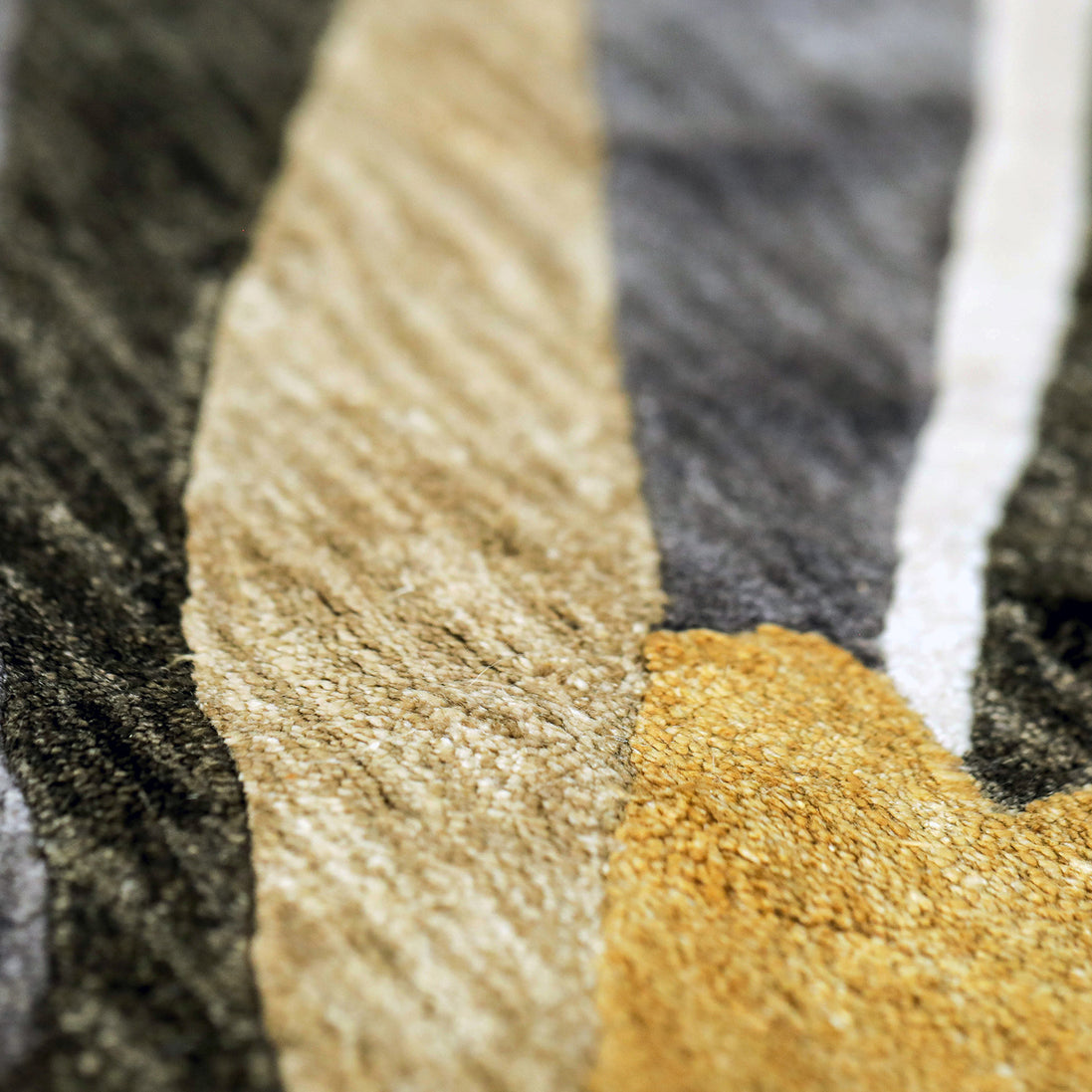 Handmade floral rug featuring a vibrant yellow blooming flower with warm neutral accents on a soft neutral background.
